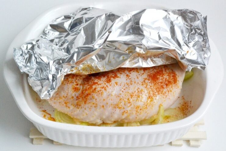 Covering the Sausage with Foil Before Baking The baking dish with the chicken sausage is covered with aluminum foil before being placed in the oven.