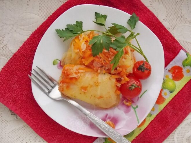 Finished Lenten Cabbage Rolls Ready to Serve A close-up shot of cooked Lenten cabbage rolls with vegetables in a savory tomato sauce.