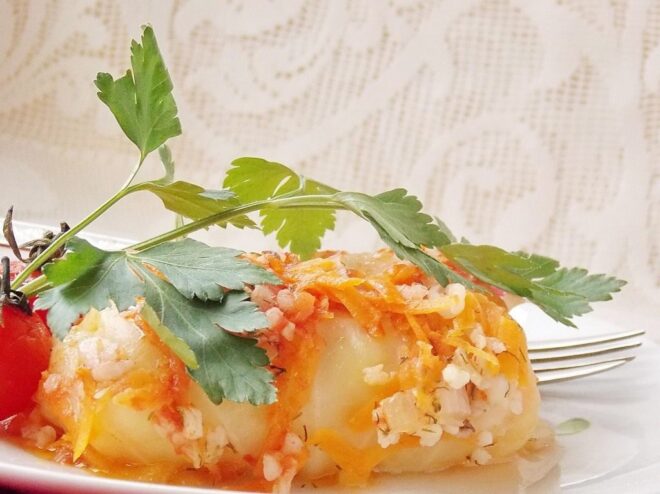 A Comforting Plate of Vegan Cabbage Rolls A serving of Lenten cabbage rolls (golubtsy) on a plate, garnished with fresh herbs.