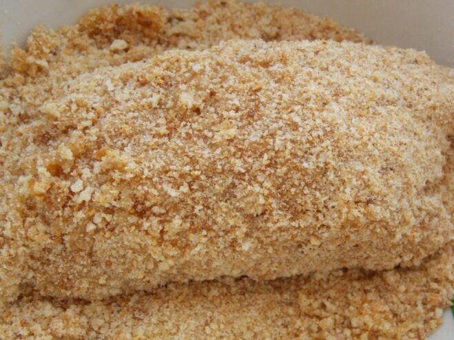 Perfectly Breaded Chicken Kyiv Ready for Chilling A perfectly formed and double-breaded raw Chicken Kyiv cutlet on a plate.