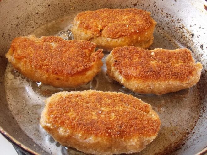 Achieving a Perfect Golden-Brown Crust Flipping the Chicken Kyiv in the pan to show a perfectly golden and crispy crust on one side.