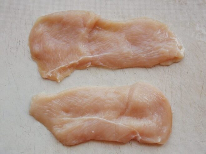 How to Prepare Chicken Fillet for Chicken Kyiv Raw chicken breast fillets flattened and ready to be filled and rolled.