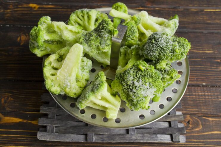 How to Steam Broccoli for Patties Broccoli florets being steamed in a steamer basket until tender.