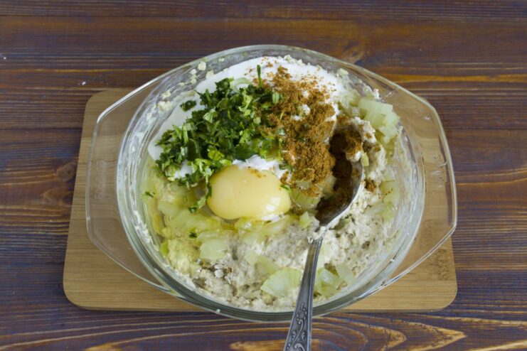 Curry powder, a raw egg, and chopped fresh herbs are added to the oatmeal mixture.