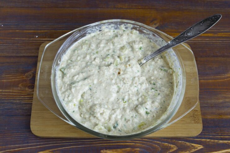 The oatmeal cutlet mixture being stirred in a bowl to combine all ingredients.