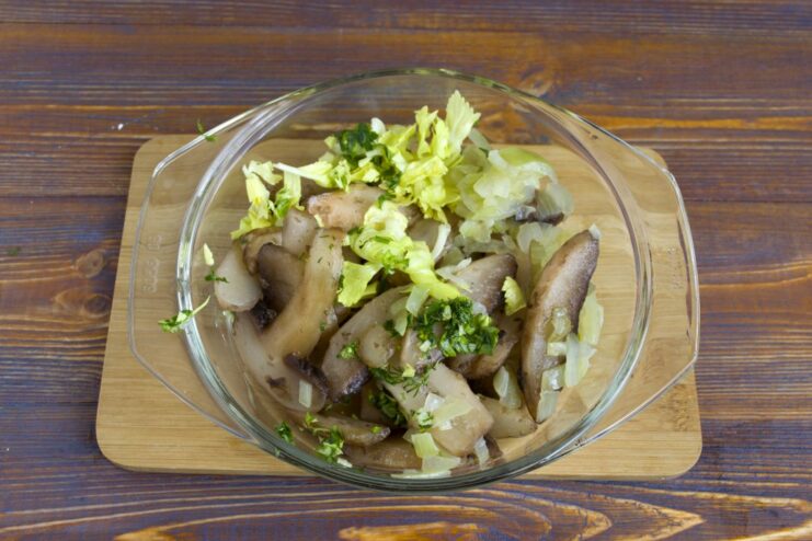 A bowl containing sautéed onions, celery, and mushrooms, ready to be blended for the gravy.