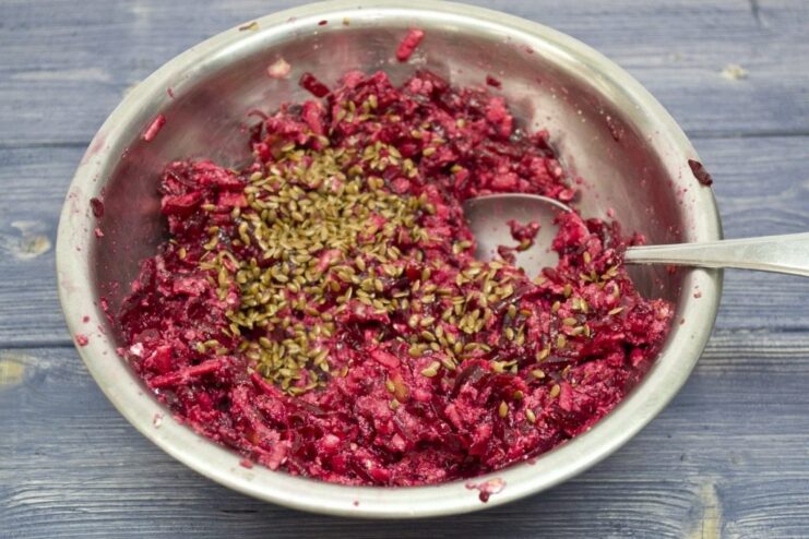 Flax seeds being added to the beet patty mixture, which is then left to rest.