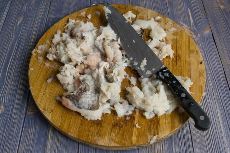 Dicing cod fillet for grinding Close-up of cod fillet being cut into large chunks for the fish cakes.