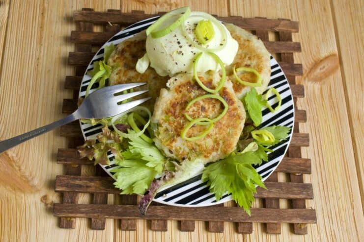 The finished dish: Farmer's Cheese Patties served with a perfectly poached egg. A close-up of the finished farmer's cheese patties, garnished and served with a poached egg.