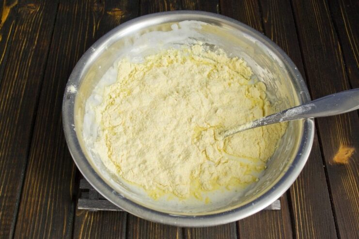 Combining Dry Ingredients for the Corn Pancakes Corn flour and baking soda being sifted into the wet ingredients to make the pancake batter.