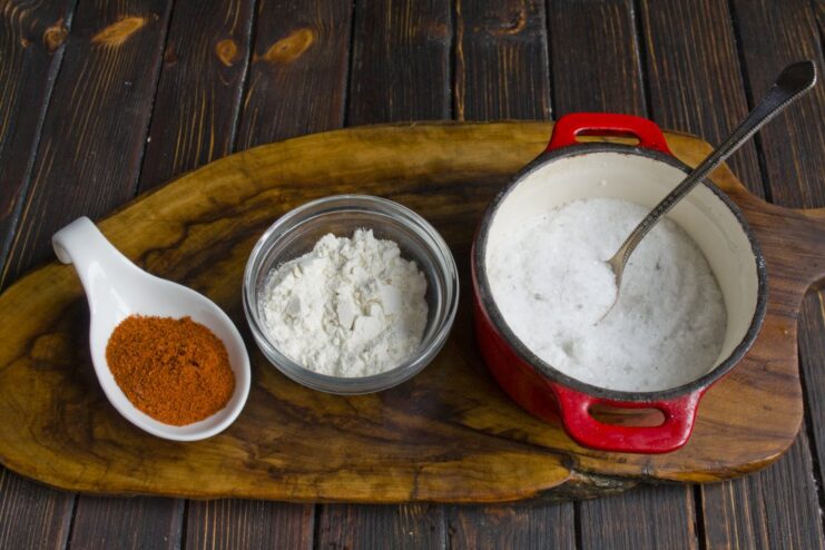 Preparing the Savory Coating for the Chicken Fillets A bowl with a mixture of paprika, potato starch, and salt for coating the chicken.