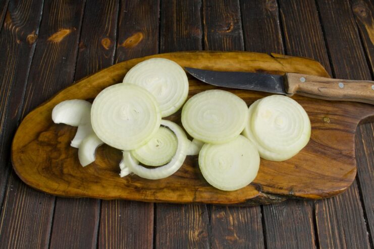 Sautéing Onions to Build a Flavorful Base Sliced onion rings being sautéed in a hot skillet.