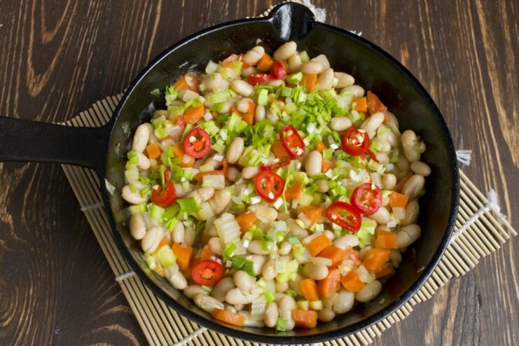 Simmering all the vegetables and beans together to let the flavors meld. The vegetable and bean ragout simmering in the pan, almost ready to serve.