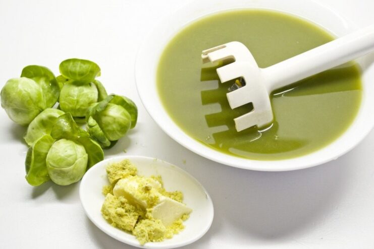 Making the Sauce: Blending Cooked Brussels Sprouts Cooked Brussels sprouts being pureed in a blender to create a smooth green sauce.