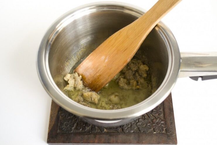 The Secret to Authentic Flavor: Rendering Beef Suet Cubes of beef kidney fat melting in a saucepan to create rendered suet.