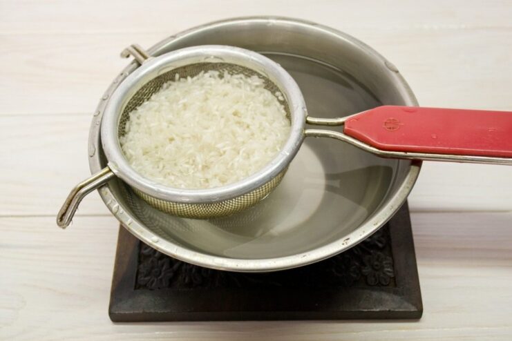 Step-by-step: How to cook perfect fluffy rice for the recipe White rice in a pot with water, ready to be cooked.