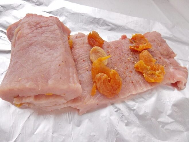 Rolling the Pork Loin with Apricot Filling Rolling a seasoned pork loin tightly around a filling of dried apricots.