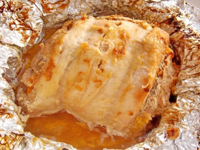 Perfectly Roasted Pork and Apricot Roll A whole roasted pork roll with a golden-brown crust, fresh out of the oven.