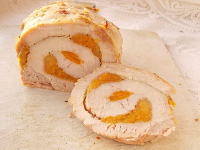 Serving the Sliced Pork Roll with Garnish Beautifully sliced pork roll with dried apricots arranged on a white plate and garnished.
