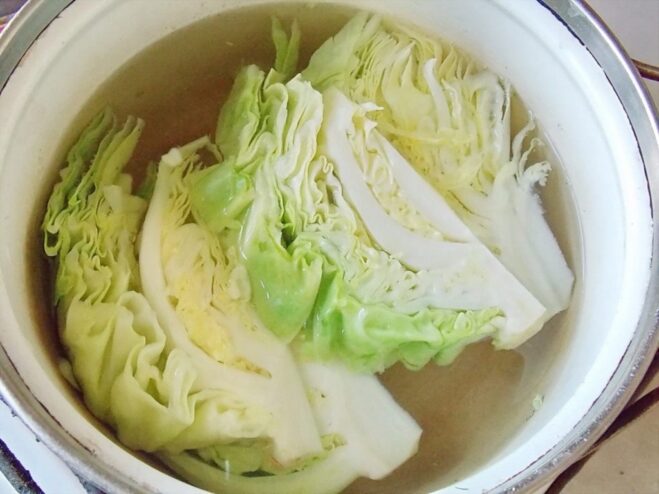 Boiling cabbage wedges in a pot of water Cabbage wedges being boiled in a large pot of water.