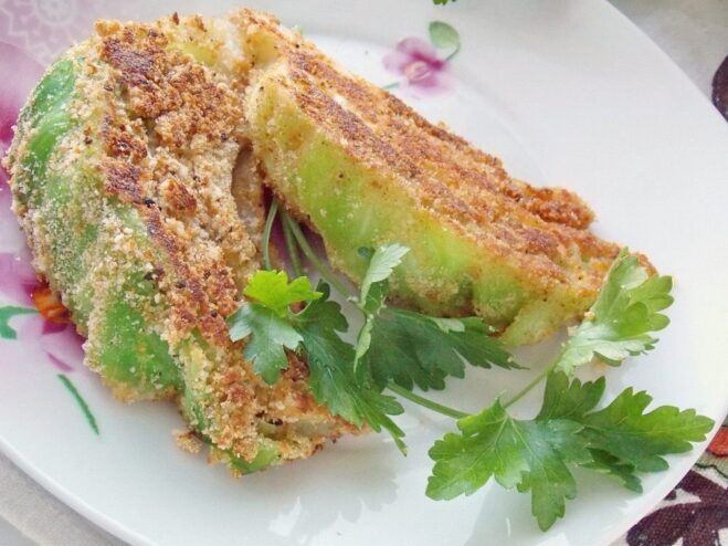 Delicious Young Cabbage Schnitzel Served on a Plate A plate of golden-brown young cabbage schnitzel, ready to be served.