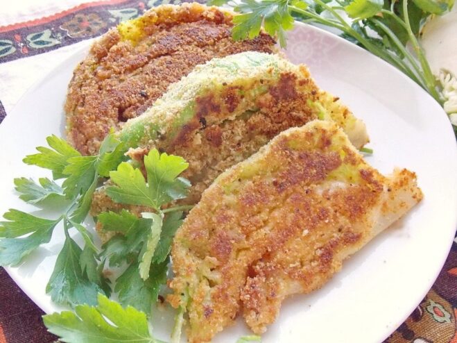 A plate of golden-brown young cabbage schnitzel, ready to be served.