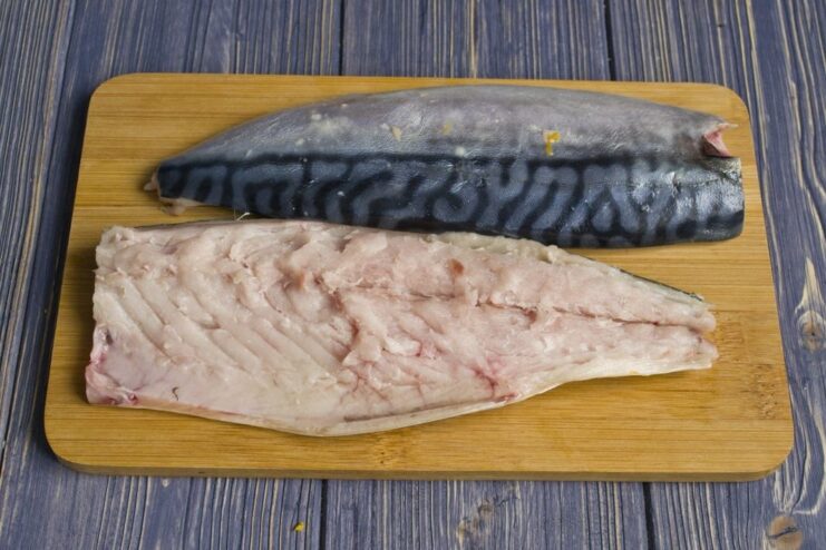 How to Debone a Mackerel Fillet with Tweezers Close-up of a mackerel fillet being deboned using tweezers.