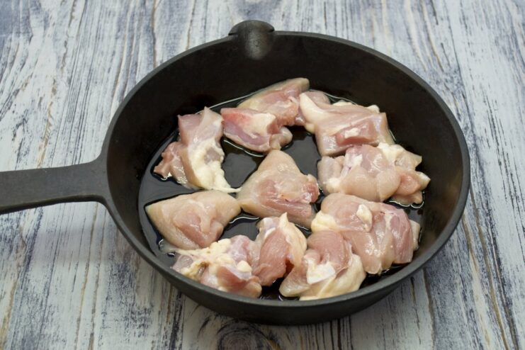 Searing Boneless Chicken Pieces for Maximum Flavor Boneless chicken pieces being seared in a hot pan until golden brown.
