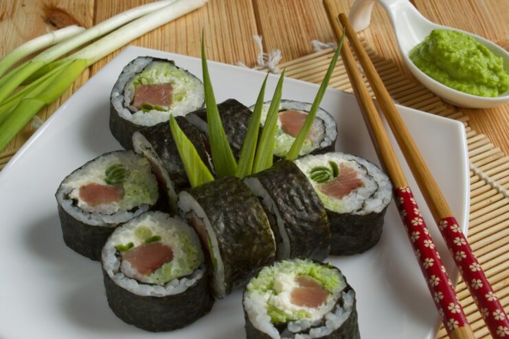 A plate of freshly made sushi maki rolls with red fish, served and ready to eat.