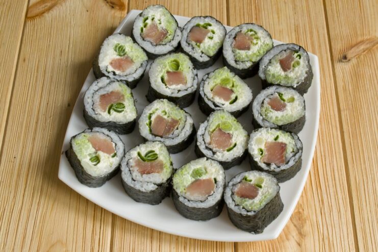 Ready to Serve: Freshly Sliced Sushi Maki on a Plate A platter of perfectly sliced sushi maki rolls ready to be served.