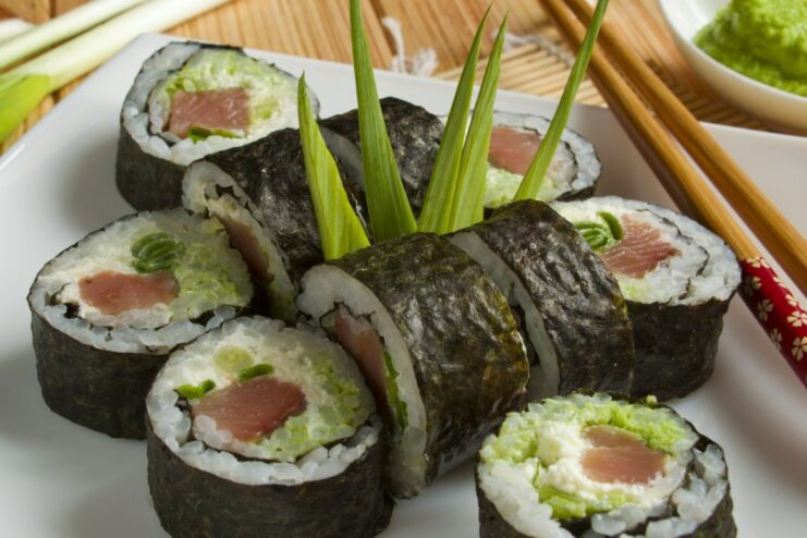 Enjoy Your Homemade Sushi Maki with Red Fish! A close-up shot of delicious sushi maki rolls with red fish and cream cheese.