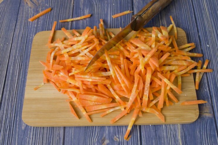 How to Julienne Carrots for a Quick Cook Time Carrots being shredded or julienned for the braised vegetable dish.