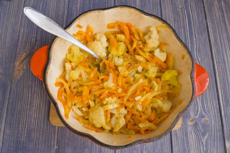 Braising Vegetables to Perfection over Low Heat A covered pan with vegetables simmering over low heat.