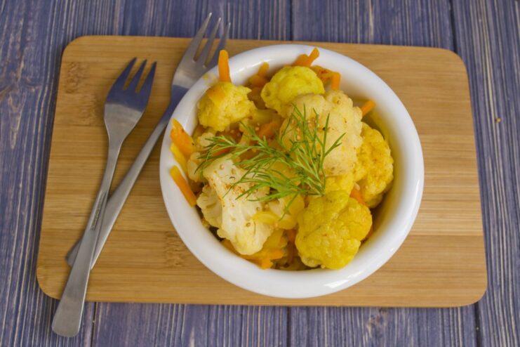 Final Dish: Braised Cauliflower with Turmeric Ready to Serve The finished dish of braised cauliflower with turmeric served in a bowl, garnished with dill.