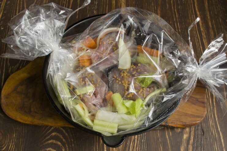 Ready to Bake: Tuna in a Roasting Bag A sealed roasting bag with tuna and vegetables on a cast-iron skillet.