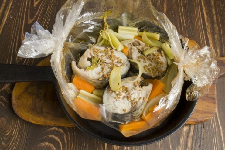 The Big Reveal: Perfectly Baked Tuna Perfectly cooked tuna and vegetables revealed after cutting open the roasting bag.