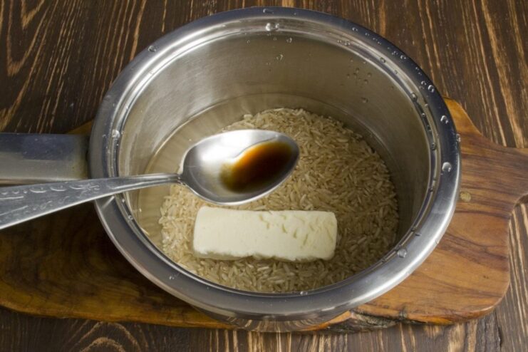 Simple Steps to Cook Perfect Brown Rice Brown rice cooking in a saucepan on the stove.