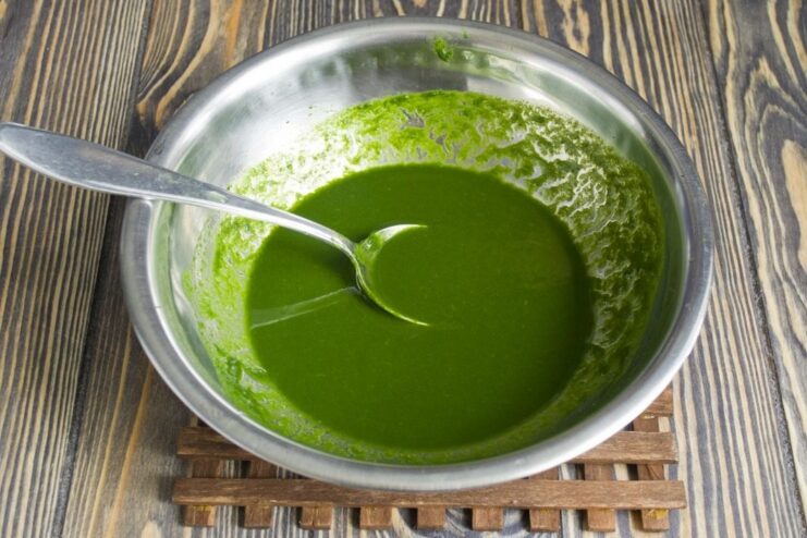 A bowl of vibrant green spinach puree, ready to be added to the rice.