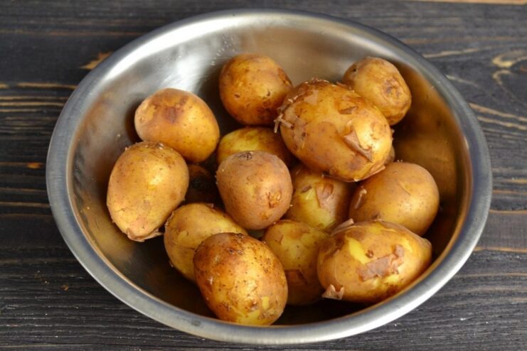 Step 1: Boiling New Potatoes Until Tender New potatoes boiling in a pot of water on the stove.