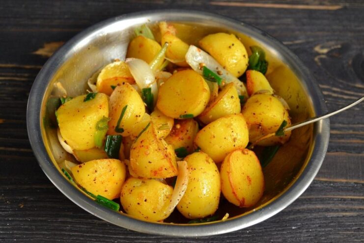 Allowing Flavors to Mingle for a Perfect Taste The finished Indian-style potatoes resting in the skillet, coated in spices.