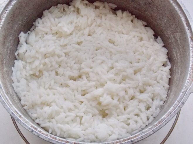 Cooking rice for the golubtsy filling A pot of cooked white rice, ready to be used for the filling.
