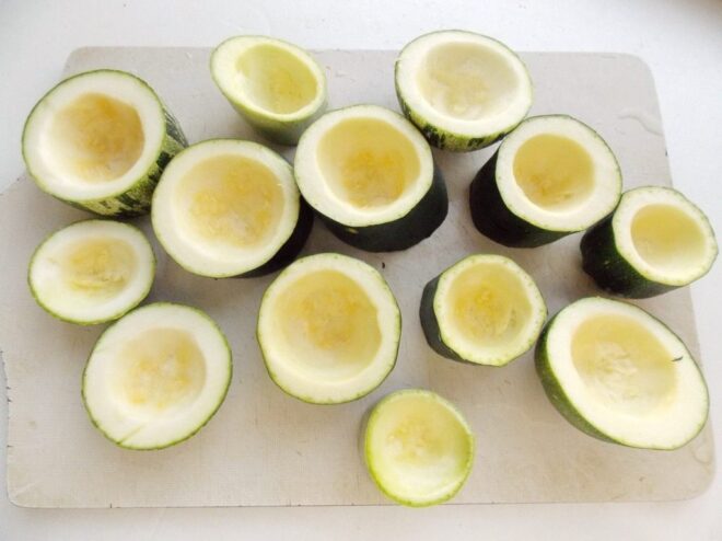 How to hollow out zucchini to make 'cups' for stuffing Zucchini cut into thick rounds with the centers hollowed out, creating cups for the filling.