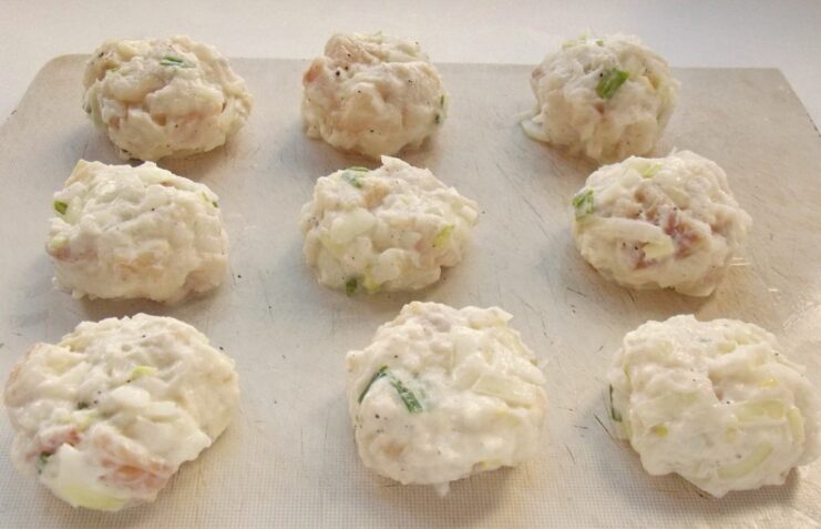 How to Shape the Perfect Fish Cutlets by Hand Hands forming the fish mixture into a round cutlet patty.