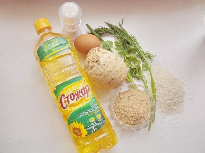 Fresh ingredients for making celery and rice patties Ingredients laid out: celery root, rice, egg, and fresh herbs.