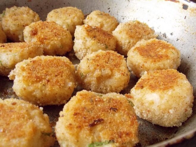 Frying the celery and rice patties until golden brown Celery and rice patties frying in a pan, turning golden brown.