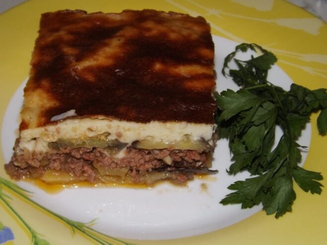 A close-up of the perfectly baked Greek Moussaka with a golden-brown top.