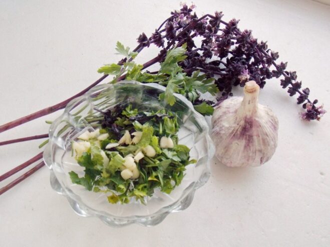 Preparing the Herb and Garlic Garnish A small bowl with finely chopped fresh herbs and minced garlic.