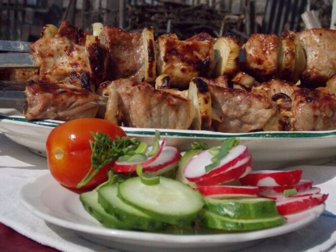 The Art of the Shashlik Marinade: A Personal Touch A close-up of marinated meat cubes in a bowl, showing the texture of the marinade.