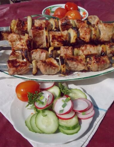 Perfectly Grilled Shashlik, Ready to Eat A close-up of juicy, perfectly cooked shashlik on a skewer over a plate.