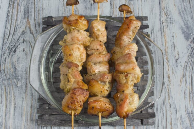 Golden-brown pork shashlik skewers, perfectly cooked in the oven. Cooked pork shashlik on skewers, fresh out of the oven.